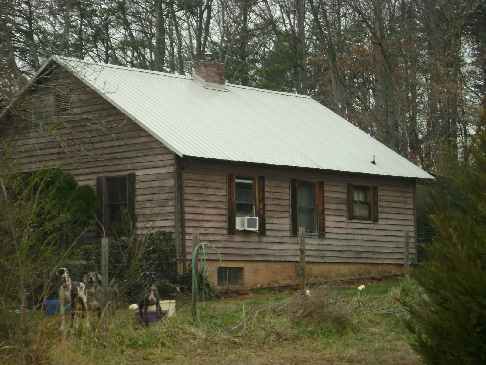 White metal roof on an old wood sided farmhouse, from a Metal Roof Installation job in Wahpeton